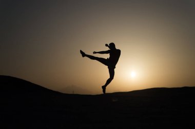 Hit your goal. Silhouette man motion jump in front of sunset sky background. Daily motivation. Healthy lifestyle personal achievements goals and success. Future success depends on your efforts now clipart