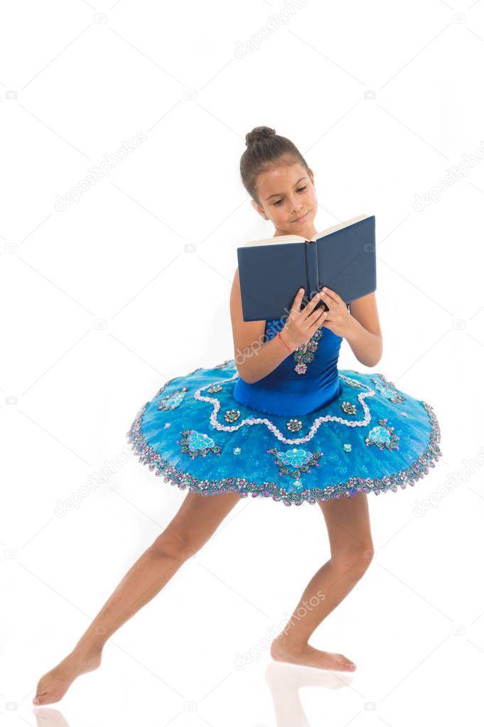 Depriving children ballerina. Most of time child dancer spend in gym training and practicing performance. No time for school studying. Girl ballerina dancing while read book. Ballet career issues