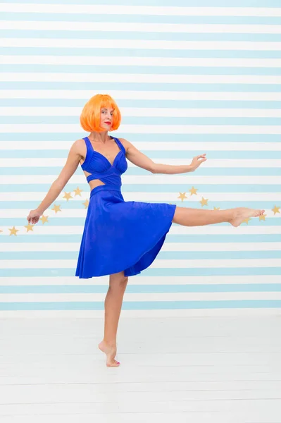 carefree girl with crazy look makes step. so much fun. crazy girl with orange hair dancing barefoot. totally carefree. beauty and summer fashion concept