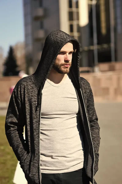 man sport fashion, bearded guy model in black hoodie or jersey and shirt sunny outdoor on blurred background