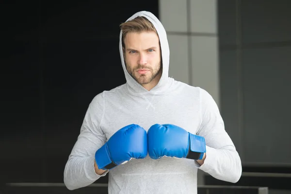 Focused sport goal achievement. Sportsman concentrated training boxing gloves. Athlete concentrated face sport gloves practice fighting skills urban background. Boxer handsome strict coach boxing — Stock Photo, Image