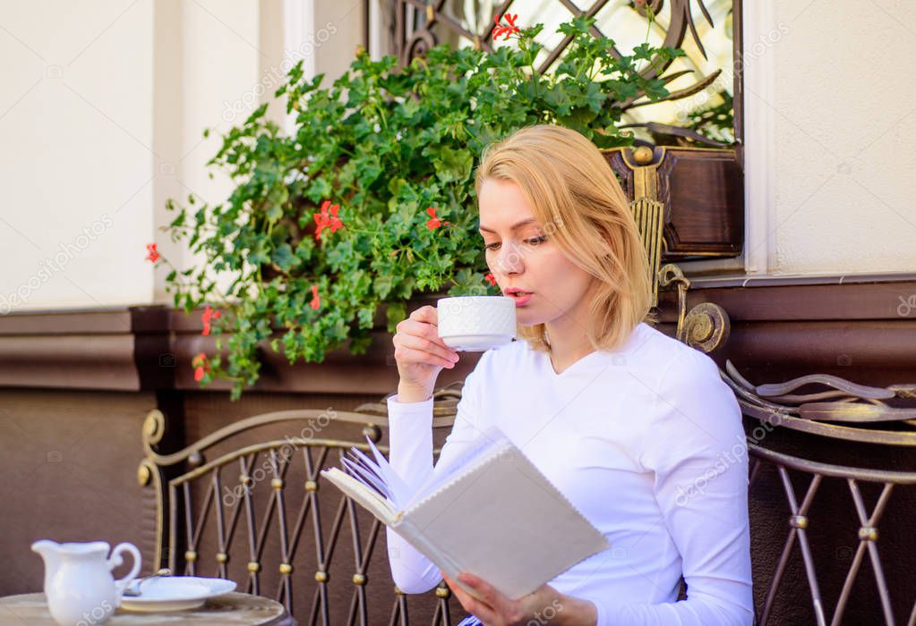 Woman have drink cafe terrace outdoors. Bookworm leisure concept. Mug of good coffee and pleasant book best combination for perfect weekend. Girl drink coffee every morning at same place daily ritual
