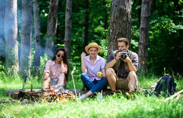 Company hikers relaxing at picnic forest background. Spend great time on weekend. Halt for snack during hiking. Camping and hiking. Company friends relaxing and having snack picnic nature background