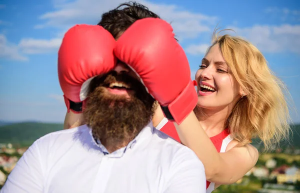 Adivinha quem joga. Relações jogo ou luta. Quebre as regras para o sucesso. Brinca e diverte-te. Truques que todas as mulheres precisam de saber. Menina sorridente rosto cobre rosto masculino com luvas de boxe. Truques impressionantes para ganhar — Fotografia de Stock