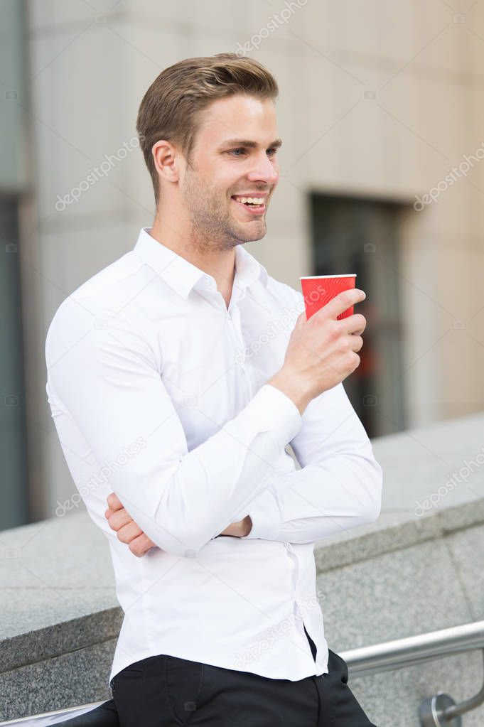 Businessman elegant guy drink tea or coffee. Break for relax and recharge energy caffeine beverage. Have cup of coffee. He prefer coffee to go. Man manager elegant shirt enjoy coffee urban background