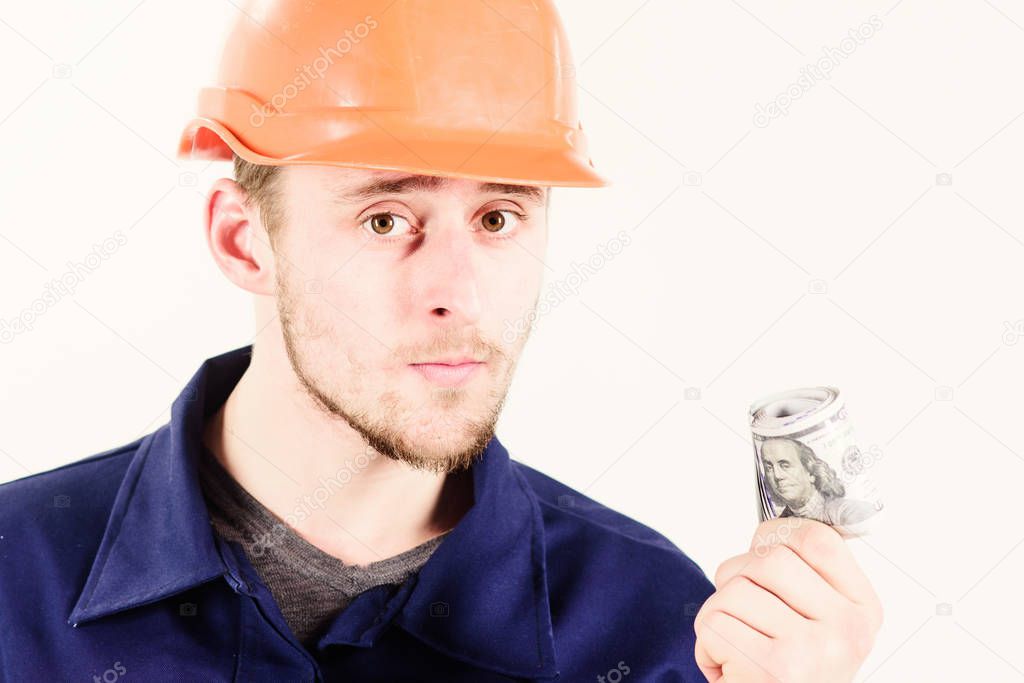 Builder earn money, repairman holds cash, banknotes in hand.