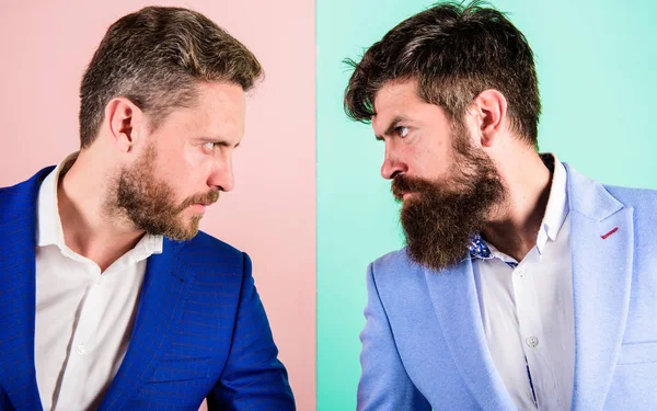 Business partners competitors or office colleagues in suits with tense bearded faces close up. Hostile or argumentative situation between opposing colleagues. Business competition and confrontation — Stock Photo, Image