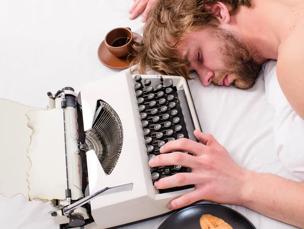 Escritor utiliza la máquina de escribir a la antigua. Autor pelo acariciado conciliar el sueño mientras escribe libro. Los adictos al trabajo se duermen. El hombre con máquina de escribir duerme. Ocupación agotadora. hombre somnoliento laico ropa de cama mientras trabajo —  Fotos de Stock