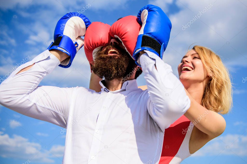 Relations game or struggle. Play and have fun. Tricks every woman needs to know. Girl smiling face covers male face boxing gloves. Break rules success. Dexterous tricks play relations. Tricky female