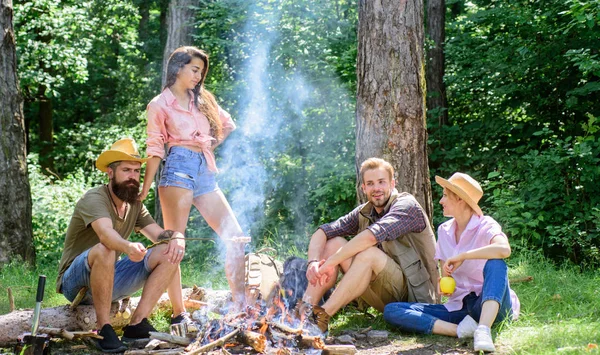 Friends enjoy summer vacation or weekend forest. Summer vacation. Company friends relaxing near campfire. Best friends spend leisure weekend forest nature background. Pleasant weekend near campfire — Stock Photo, Image