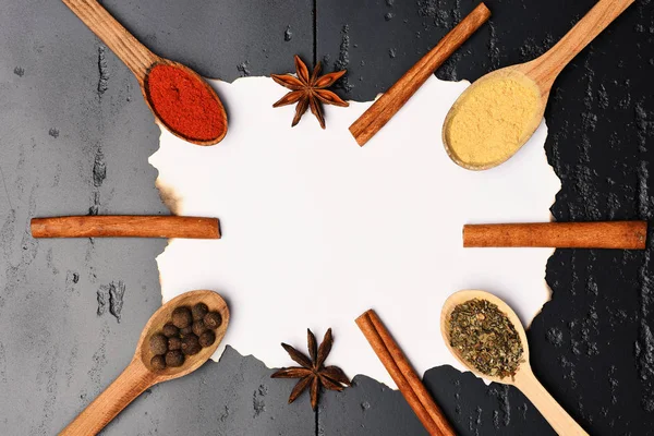 Food art. Set of dry spices on grey texture background.