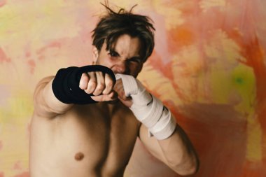 Siyah kimono kemerli ve kollarında bandaj olan adam.