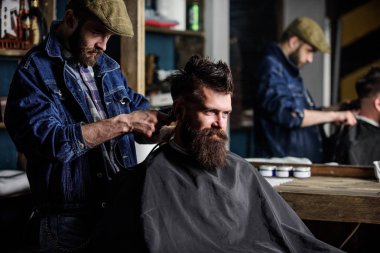 Hipster istemci Başlarken saç kesimi. İstemci ense üzerinde kırpma makası kesme saçlı berber. Kuaför saç kesme makinesi ile sakallı adam berber arka plan saç kesimi üzerinde çalışır. Hippi saç modeli kavramı.