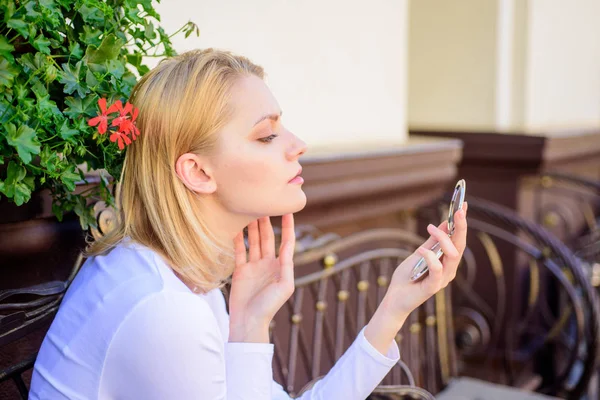 Girl looking in mirror check her appearance. Girlish secrets concept. Woman looking in her pocket mirror. Check if everything is right before date. Beauty treatment and skin care concept