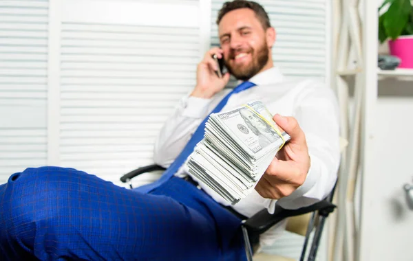 Get cash in few minutes. Banking support line concept. Man successful businessman phone conversation ask service. Businessman rich bearded guy sit office with lot of cash money. Bank loan or credit — Stock Photo, Image