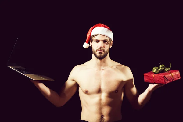 santa muscular man with laptop and present