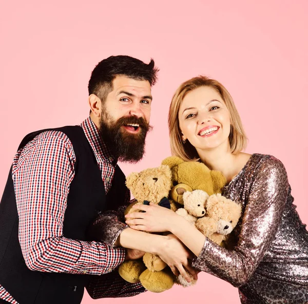 Pareja en el amor sostiene montón de osos de peluche en rosa — Foto de Stock