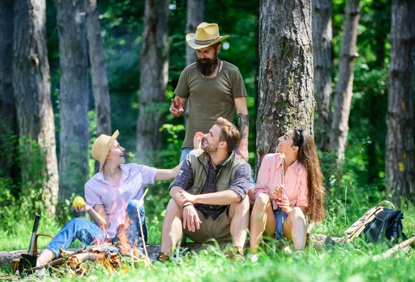 Plan for perfect day hike picnic. Company friends relaxing picnic in forest. Friends relaxing near bonfire. Friends enjoy vacation in nature forest background. Pleasant hike picnic in forest