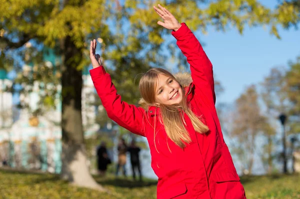 Full of life energy. Keep body warm clothes autumn days. Autumn outfit concept. Kid girl wear coat for autumn season nature background. Child cheerful on fall walk. Warm coat best choice for autumn