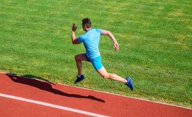 Runner havada yakaladı. Kısa mesafe sorun çalışan. Alttan yukarıya ittirmek hız. Koşmak atlet parça çimen arka plan. Şekil çalıştırın. Yeni başlayanlar için çalışan sorun. Sprinter eğitim, stadyum parkur