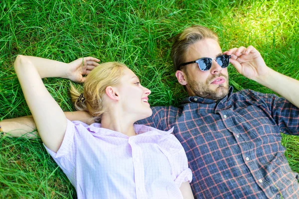 Guy and girl happy carefree enjoy freshness of grass. Closer to nature. Couple in love relaxing lay at meadow. Nature fills them with freshness and peace. Man unshaven and girl lay on grass meadow — Stock Photo, Image