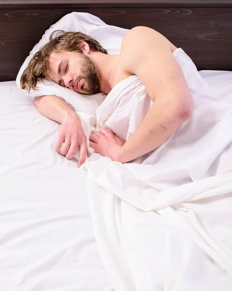 Power napping may help you get through day. Have nap relax. Man sleepy drowsy unshaven bearded face covered blanket having nap. Guy lay under white bedclothes. Man unshaven handsome relaxing bed