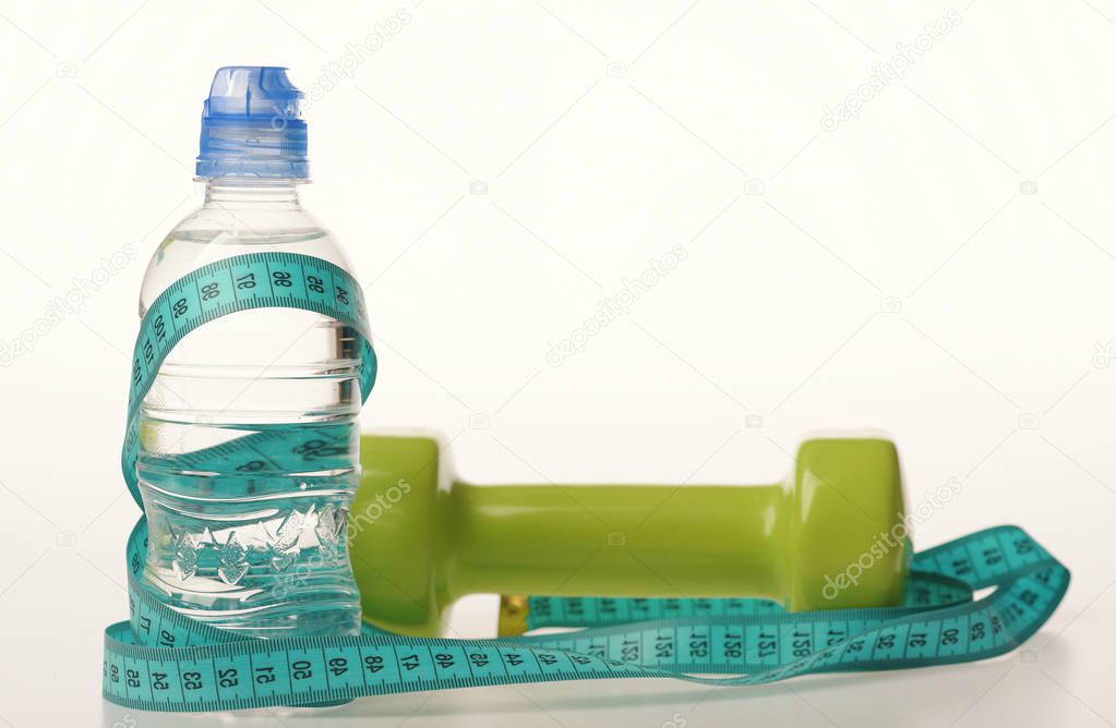 Healthy regime equipment. Water bottle tied with cyan measure tape