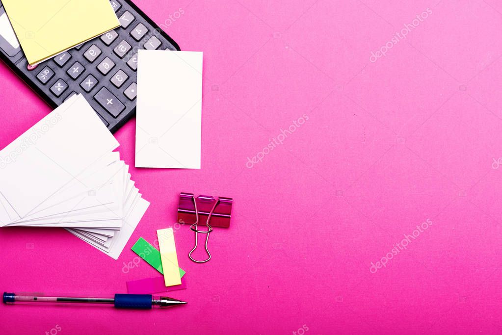 Bookmarks, note papers and white cards with pen on pink