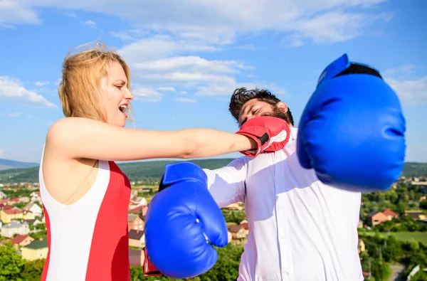 Signs you are henpecked husband. Leadership family relations. Couple boxing gloves fight sky background. Girl confident strength power. Gender domination concept. Henpecked guy attacked by wife — Stock Photo, Image