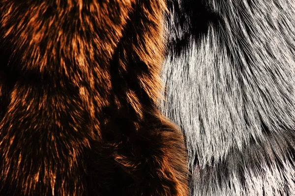 Dyed furry coats in brown and grey color, close up. — Stock Photo, Image