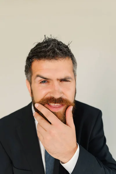 Человек с густой бородой и голубыми глазами на сером фоне — стоковое фото