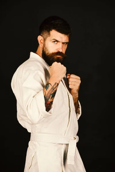 Karate man with confident face in uniform.