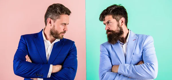 Business partners competitors in suits with tense bearded faces. Businessmen stylish appearance jacket pink blue background. Tense face expression competitors. Business competition and confrontation — Stock Photo, Image