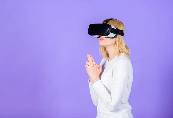 Woman head mounted display violet background. Virtual reality shooting gallery. Girl killer technology vr headset play shooter game. Lady with weapon gesture. Enthralling interaction virtual reality