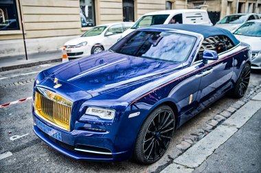 Lüks Supercar Royce Rolls Royce 'u Paris' te caddeye park etmiş mavi ve altın rengi bir hayalet olarak gösteriyor. Rolls Royce Rolls-Royce ünlü pahalı otomobil markasıdır.