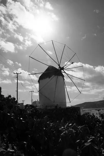 Old windmill in Mykonos, Greece. Whitewashed building with sail and straw roof with nice architecture. Windmill on mountain landscape by sea. Vacation on mediterranean island. Landmark and attraction — Stock Photo, Image