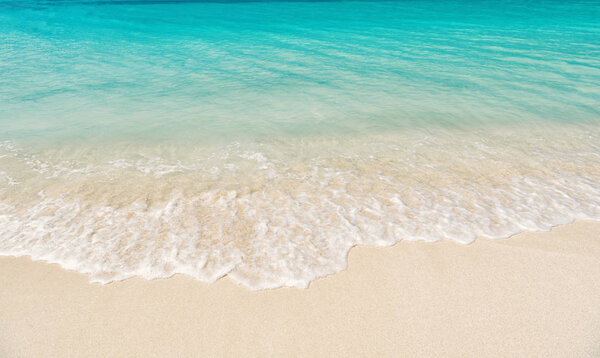 wavy sea, ocean water background on sand coast in Antigua