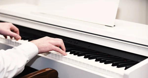 Muziek artiesten handen met witte manchetten pianospelen. — Stockfoto