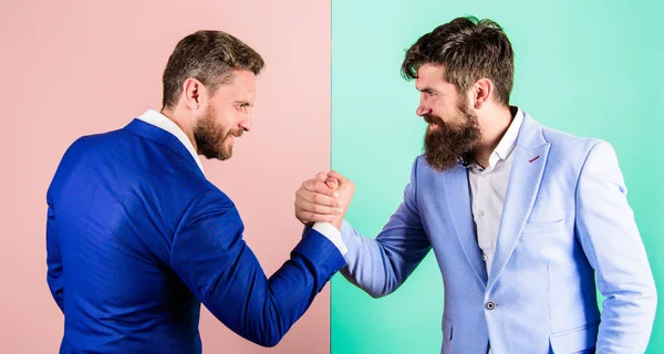 Business partners competitors office colleagues tense faces ready to compete in arm wrestling. Business competition and confrontation. Hostile or argumentative situation between opposing colleagues — Stock Photo, Image