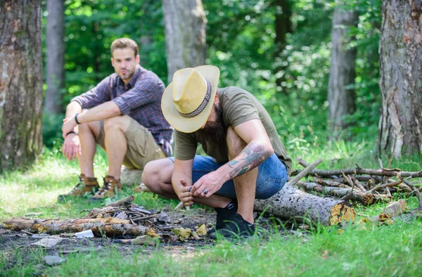 Camping i skogen. Män på semester. Man brutala skäggiga hipster förbereder brasa i skogen. Ultimate guide till eldar. Ordna woods kvistar eller trä pinnar. Hur man bygger brasa utomhus — Stockfoto