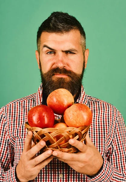 Guy presents homegrown harvest. Farmer with seductive face