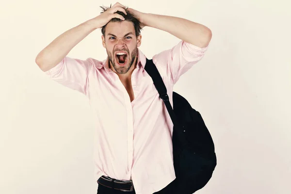 Man with excited, angry face and messy hair wears backpack