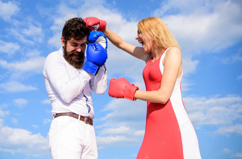 Be ready defend your point view. Defend your opinion in confrontation. Relations and family life as everyday struggle. Couple in love fighting. Man and woman fight boxing gloves blue sky background