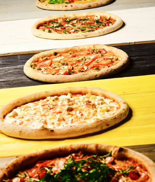 Different pizzas set for menu. Pizza circles with meat, mushrooms, tomatoes and cheese on wooden background. Italian pizza and taste concept. Take away food with various ingredients and crunchy edges — Stock Image Different Pizzas Set Menu Pizza Circles Meat Mushrooms Tomatoes Cheese Stock Photo