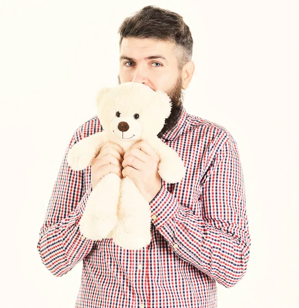 Хлопець з бородою обіймає м'яку іграшку з ніжністю . — стокове фото