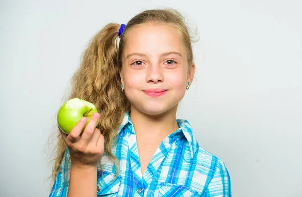 Kid girl eat green apple fruit. Vitamin nutrition concept. Reasons eat apple every day. Nutritional content of apple. Apple a day keeps doctor away. Good nutrition is essential to good health