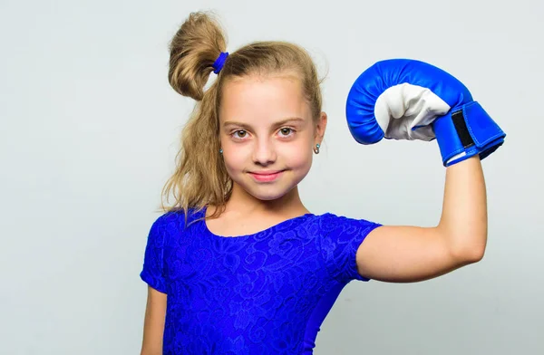 She feels as winner. Upbringing for leadership and winner. Feminist movement. Strong child proud winner boxing competition. Girl child happy winner with boxing gloves posing on grey background — Stock Photo, Image