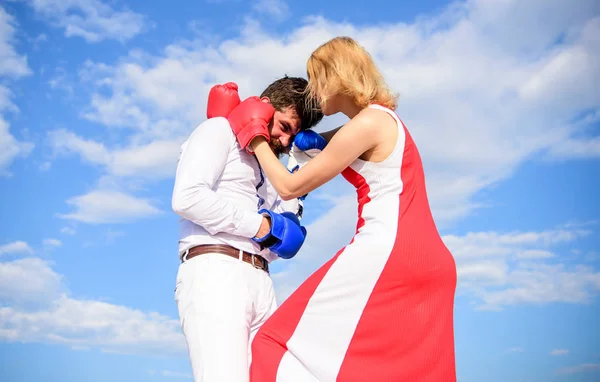She knows how to defend herself. Girl confident in strength power. Struggle equality rights. Gender domination concept. Learn how to defend yourself. Man and woman boxing gloves fight sky background