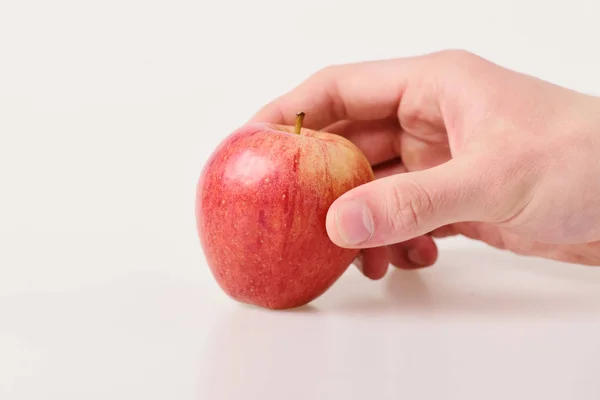 Food and healthy lifestyle concept. Male hand holds red apple — Stock Photo, Image