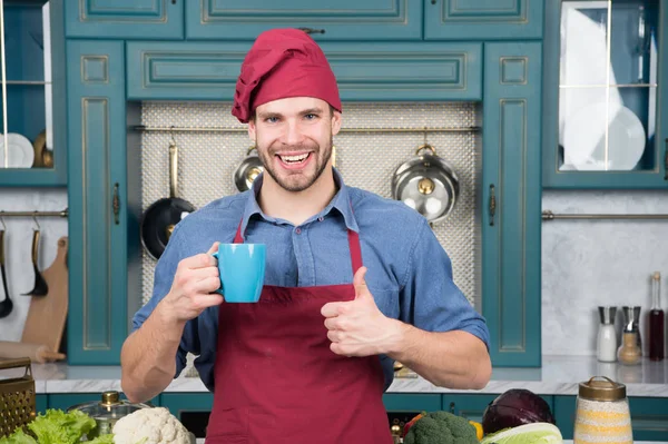 Man chef hold mug drink beverage. Great taste. Chef prepared delicious hot beverage. Beverage drink recipe. Smoothie healthy beverage concept. Man chef wear apron cooking in professional kitchen — Stock Photo, Image